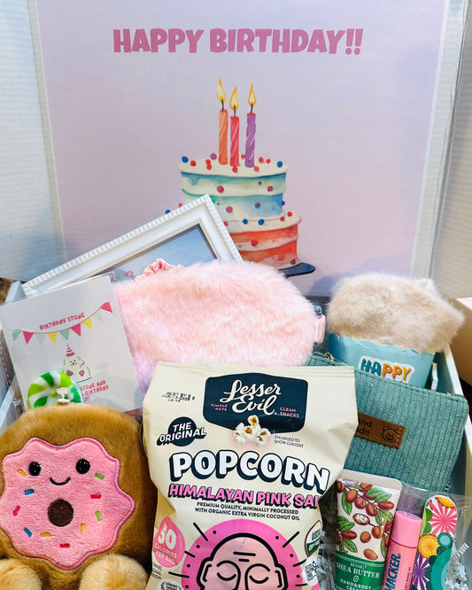 Birthday-themed items including popcorn, plush toys, and a card with a cake and candles.