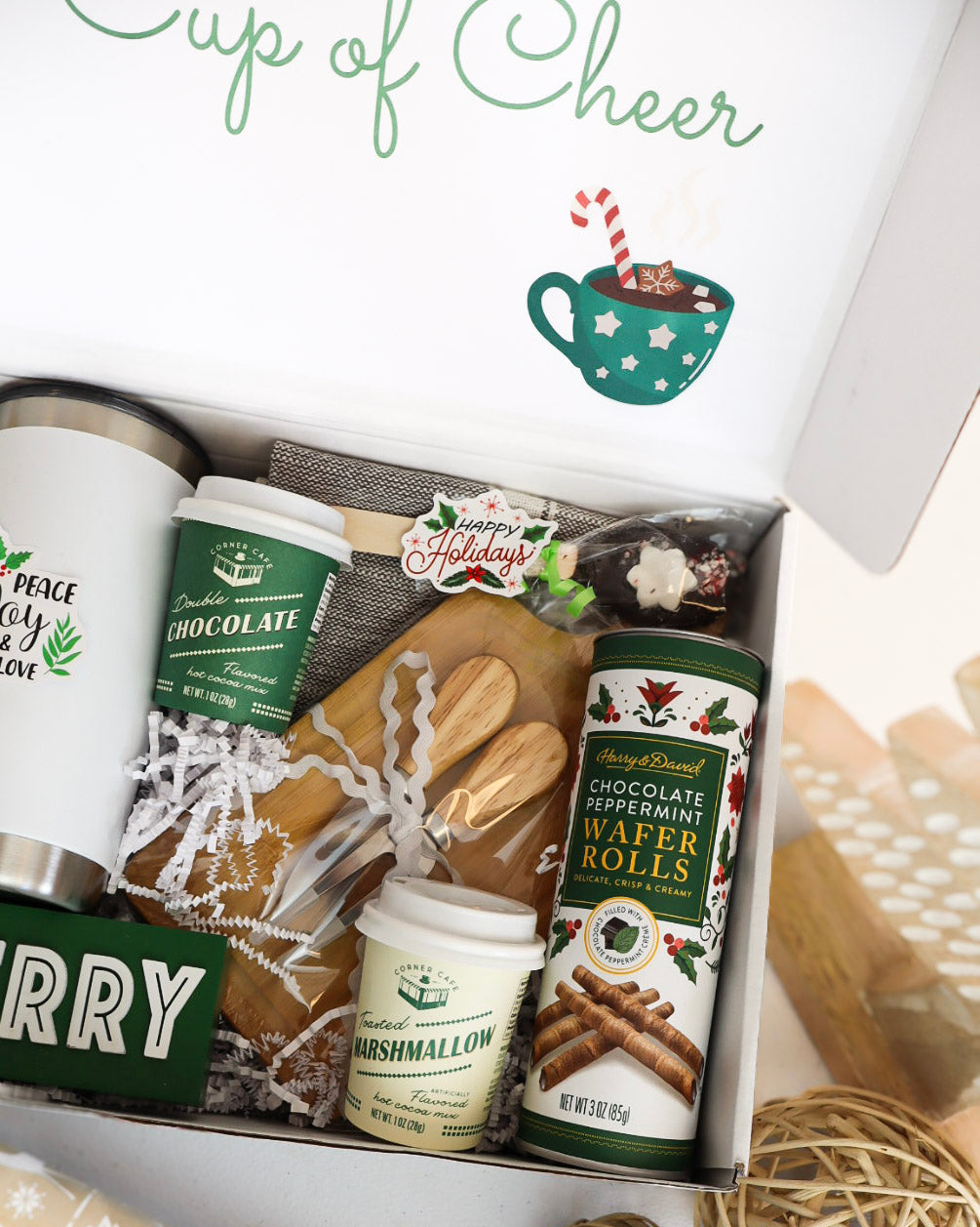 Gift box with holiday-themed items including a mug, cookies, and a jar of marshmallows.