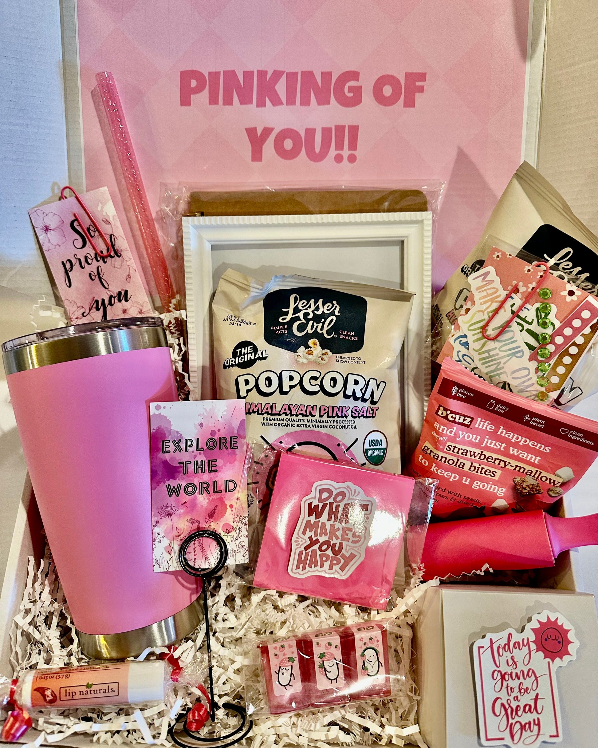 Gift box with pink tumbler, snacks, and decorative items with 'Pinking of You!' text.