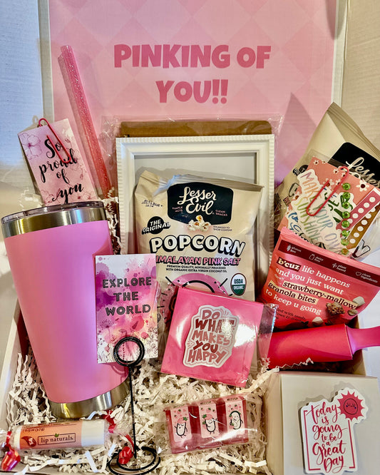 Gift box with pink tumbler, snacks, and decorative items with 'Pinking of You!' text.